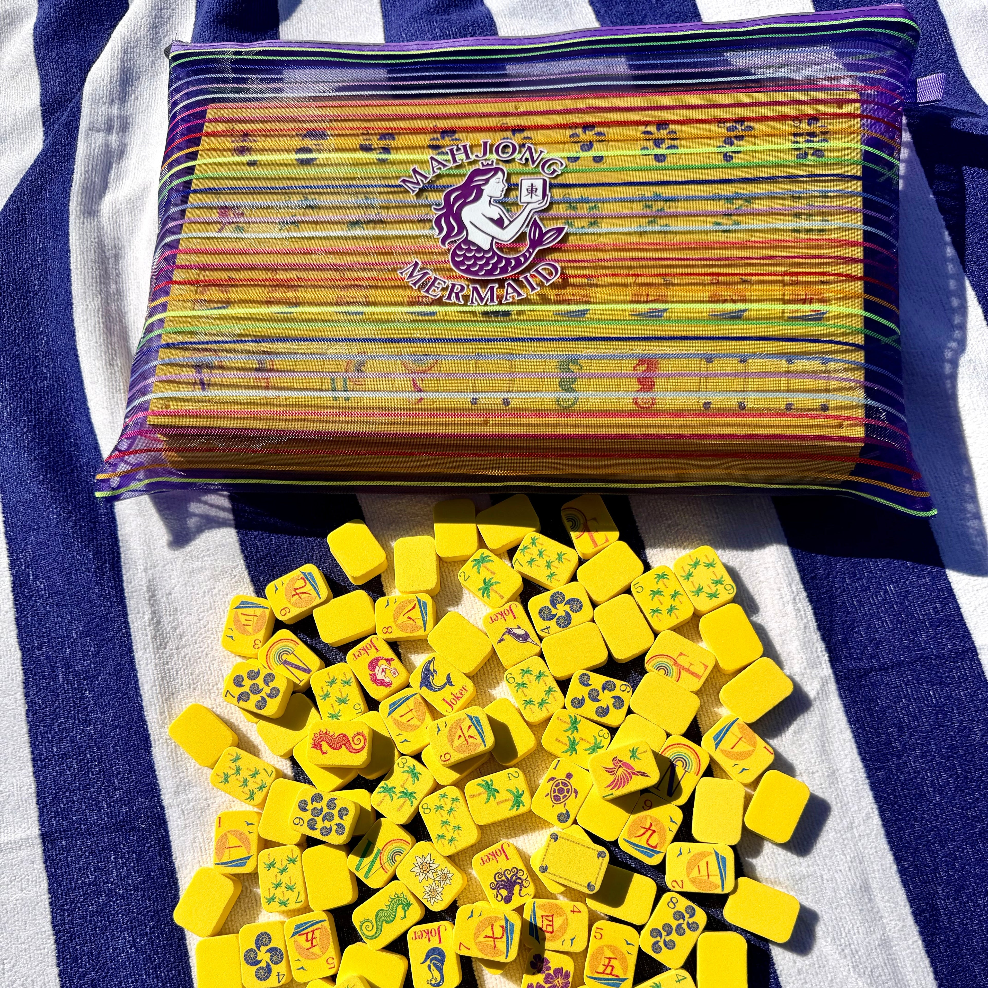 Yellow floating mahjong tiles with colorful striped mesh tile bag