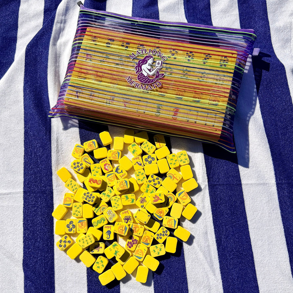 Yellow floating mahjong tiles with colorful striped mesh tile bag