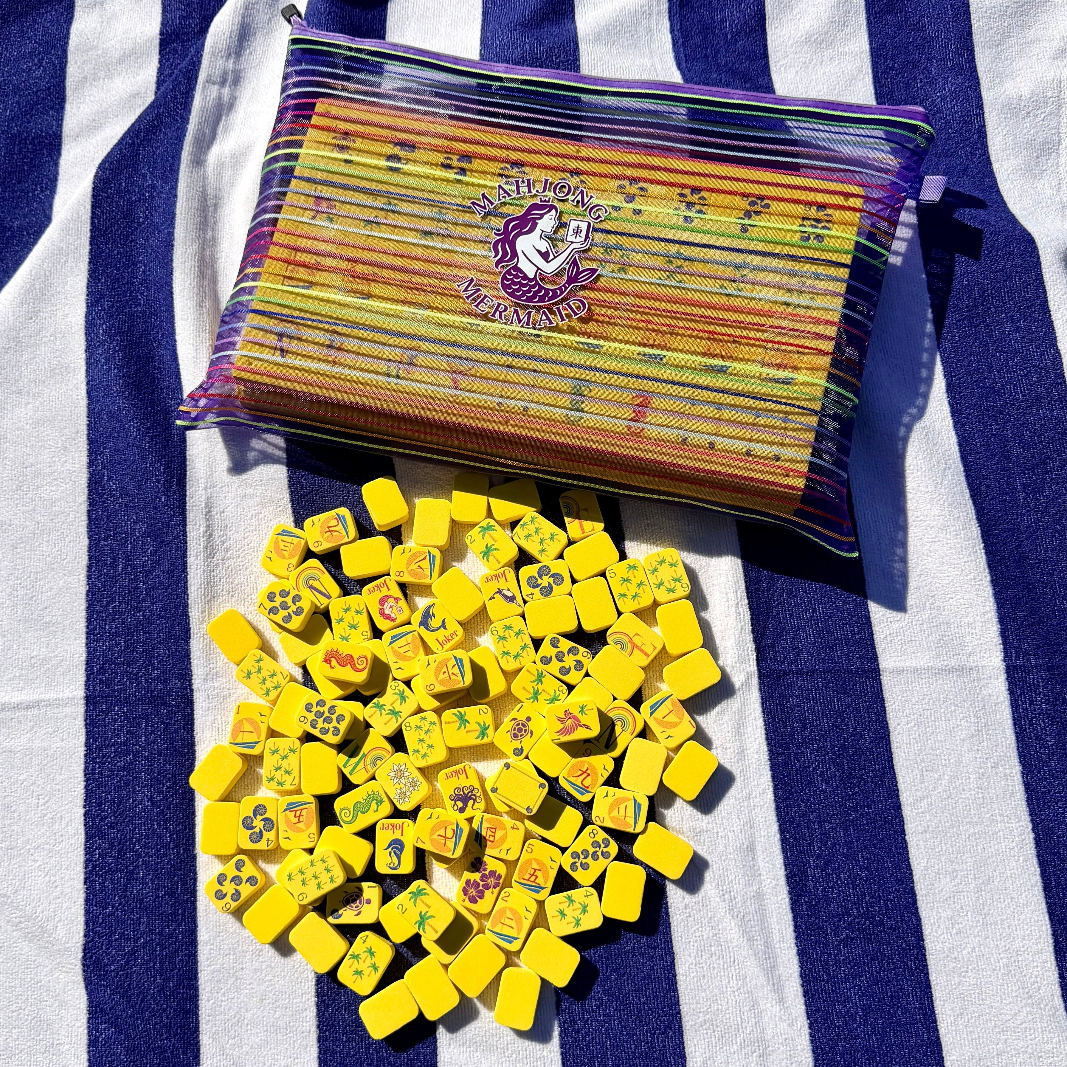Yellow floating mahjong tiles with colorful striped mesh tile bag
